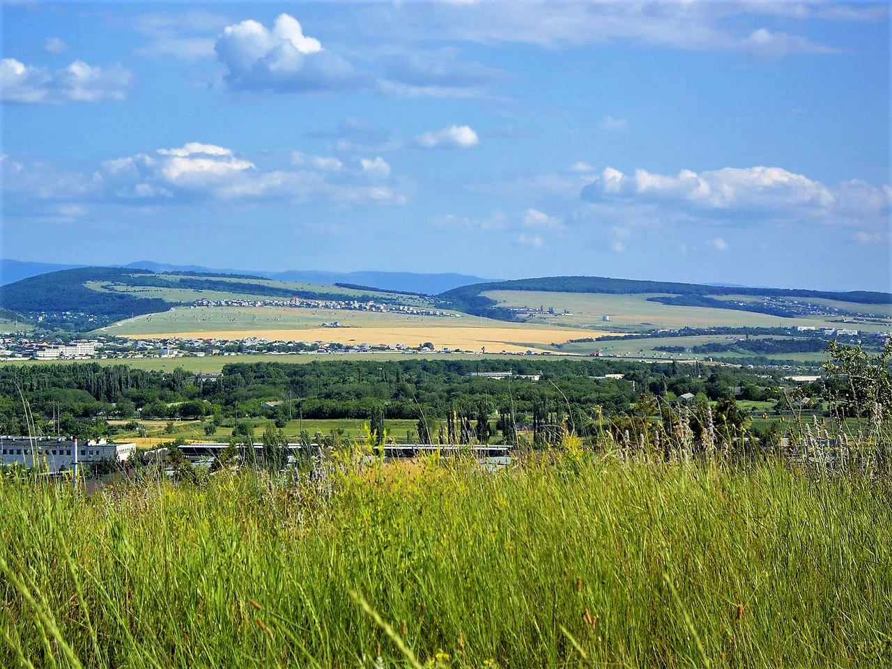 View from The Third ridge to The Second ridge. At background - The Main ridge of Crimean mountains. In front The Second ridge - Zavodskoye Airfield at border of Simferopol
