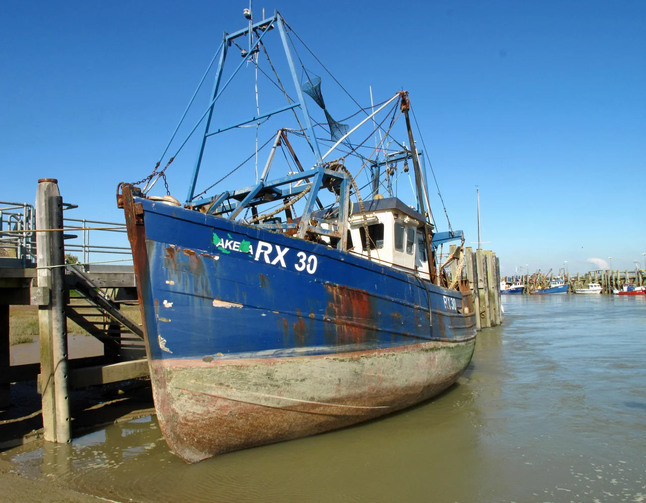 The fishing vessel Akela tied up next to the RNLI slipway at Rye Harbour. RX30 is 12.19 metres in length and made of wood, she was built in 1966 and is still fishing.