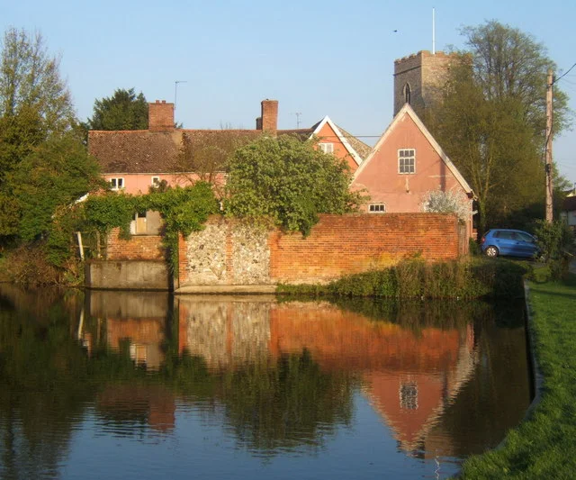 Village pond at Haughley Seen on a lovely spring evening, with an attractive group of cottages and the church beyond.  The pond appears to be part of a moat system surrounding a former motte and bailey castle complex.