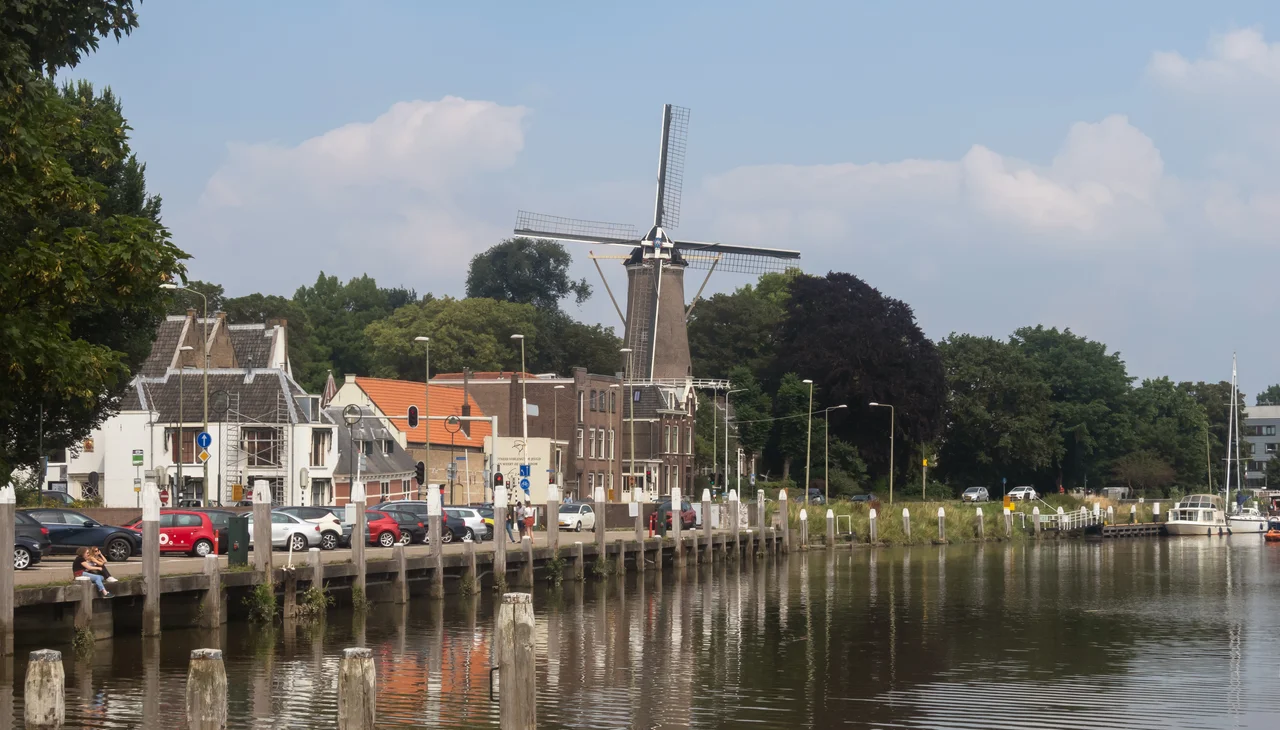 Gouda, windmill (molen 't Slot) along the river (Hollandse IJssel )