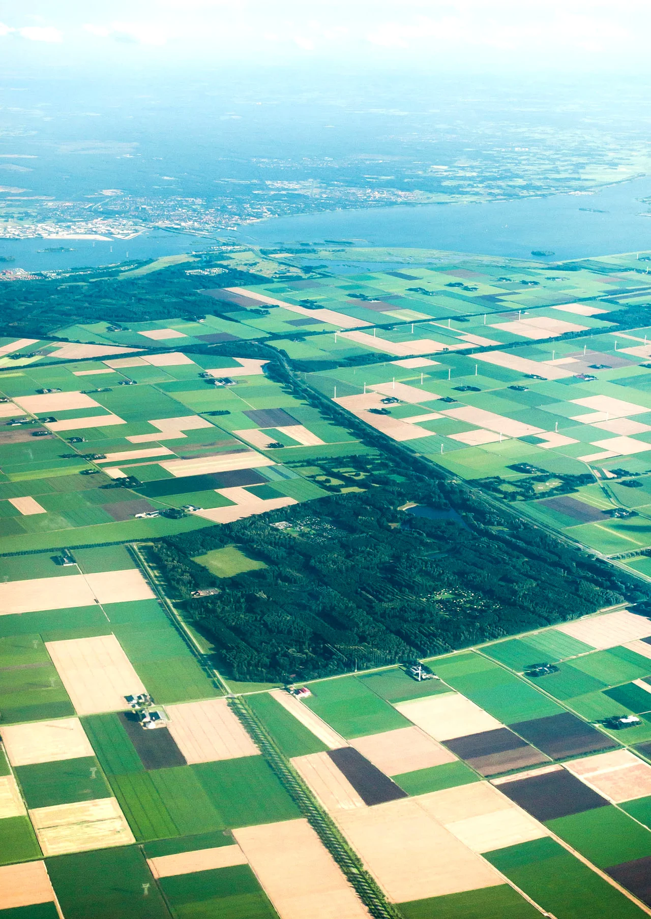 Aerial view of the Larserbos in the foreground, and in the background the Harderbos, the Wolderwijd lake and the town of Harderwijk. Elevation is around 2000 metres/6000 feet.