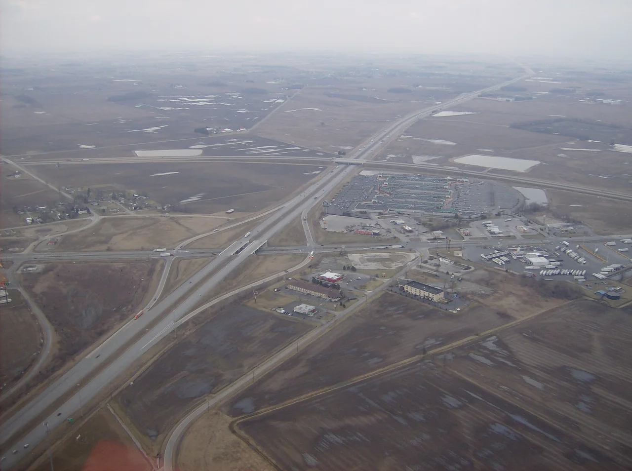 Aerial view of West Lancaster, a community in southern Jefferson Township, Fayette County, Ohio, United States.  The village of Octa lies primarily just off the bottom edge of the picture, although its village limits extend along the road that appears from the picture's bottom edge.  Picture taken from a Diamond Eclipse light airplane at an altitude of 2,500 feet MSL at an bearing of approximately 5º.  The interchange is Interstate 71 over State Route 435, and the divided highway's overpass in the background is U.S. Route 35 passing over the interstate.
