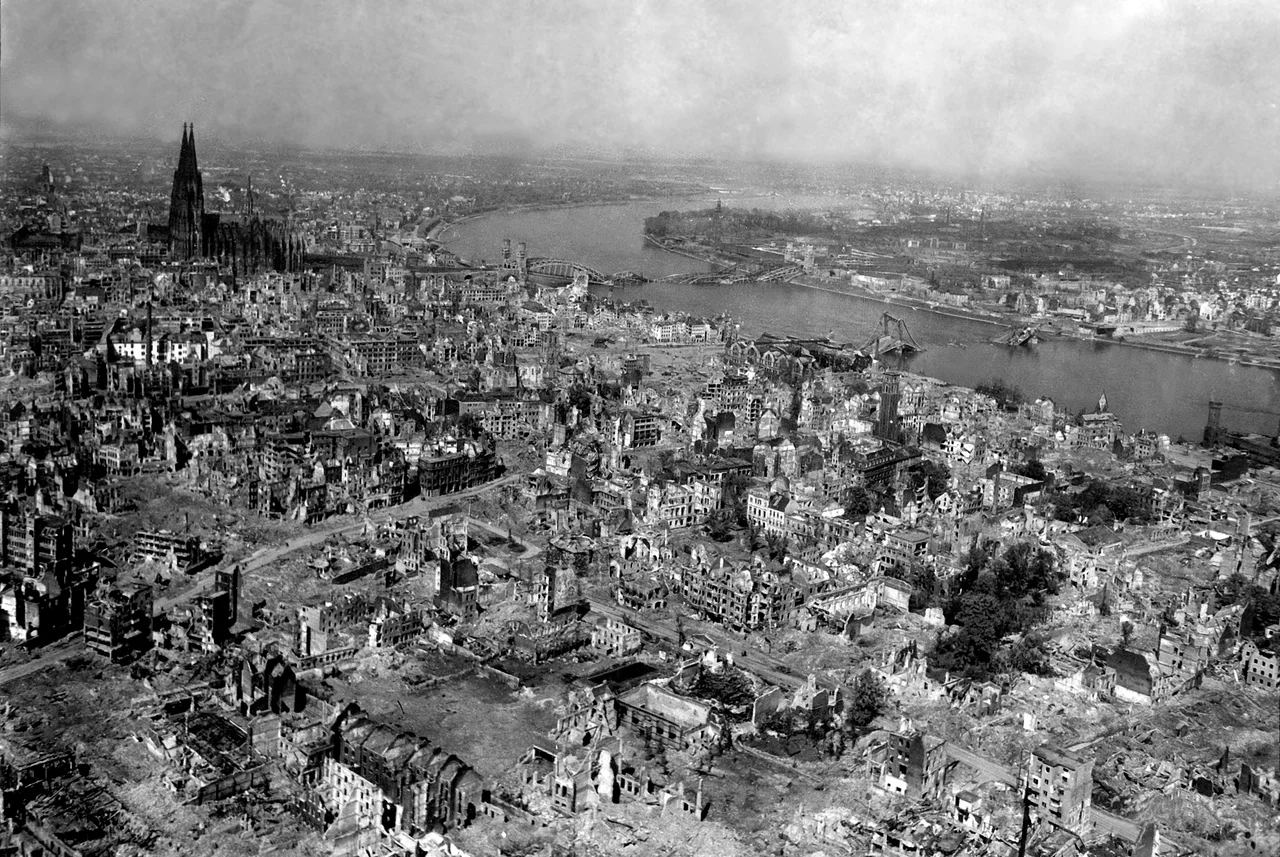 The Kölner Dom (Cologne Cathedral) stands seemingly undamaged (although having been directly hit several times and damaged severely) while entire area surrounding it is completely devastated. The Hauptbahnhof (Köln Central Station) and Hohenzollern Bridge lie damaged to the north and east of the cathedral. Germany, 24 April 1945.
