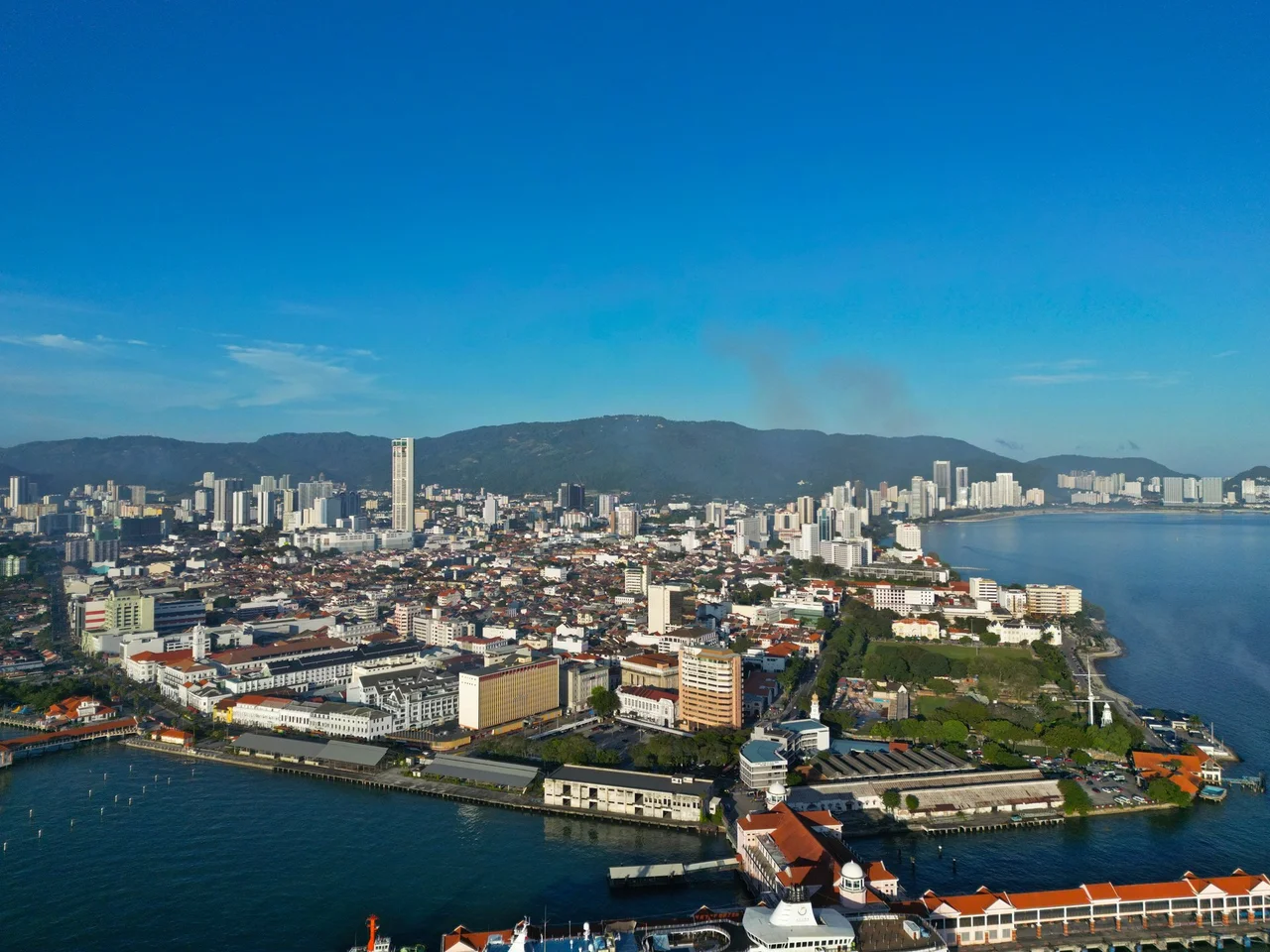 The skyline of downtown George Town as seen from the Penang Straits in December 2023
