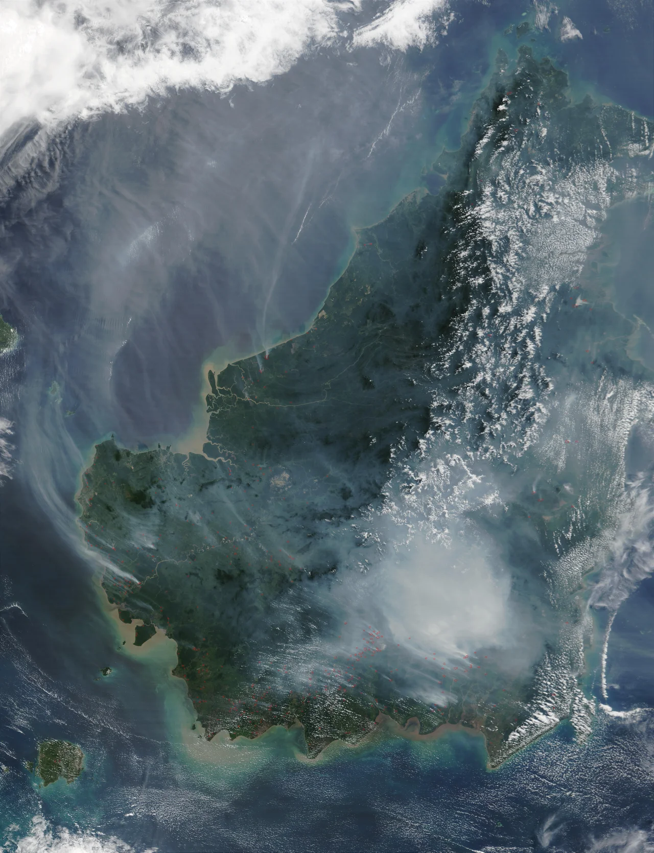 Thick smoke in Borneo resulting from slash-and-burn practices. The red squares on the image denote fires, picked up by the Moderate Resolution Imaging Spectroradiometer (MODIS) on the Terra satellite.