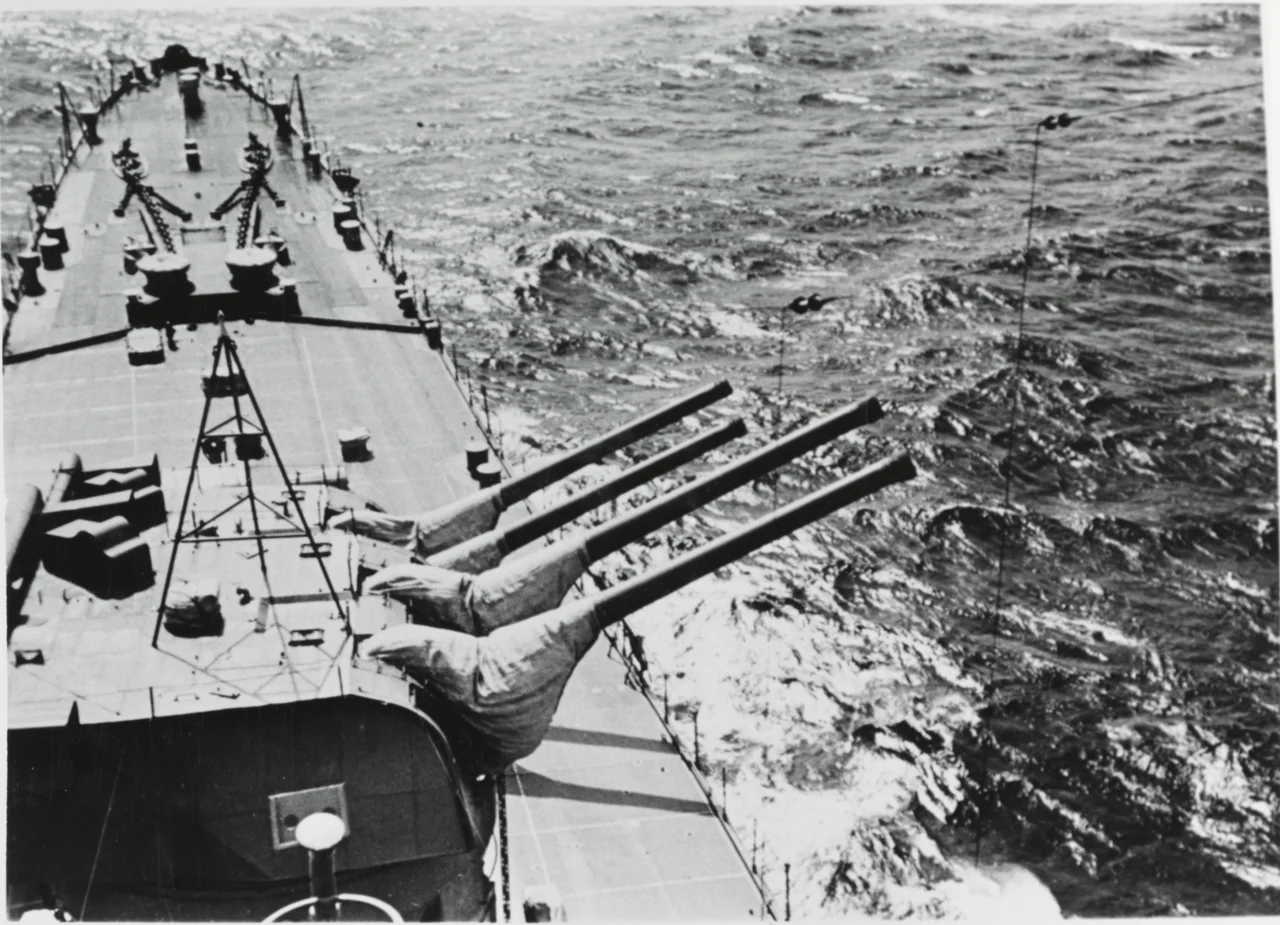 The U.S. Navy heavy cruiser USS Salt Lake City (CA-25) in action during the Battle of the Komandorski Islands on 26 March 1943, with an enemy salvo landing astern.