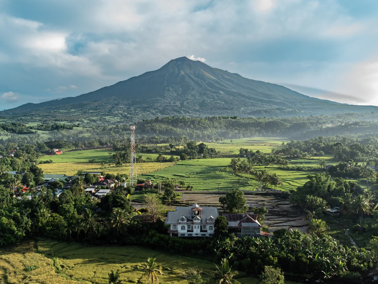 Showing a mansion as foreground, i took the photo of Mt. Kanlaon spewing small amount of smoke.