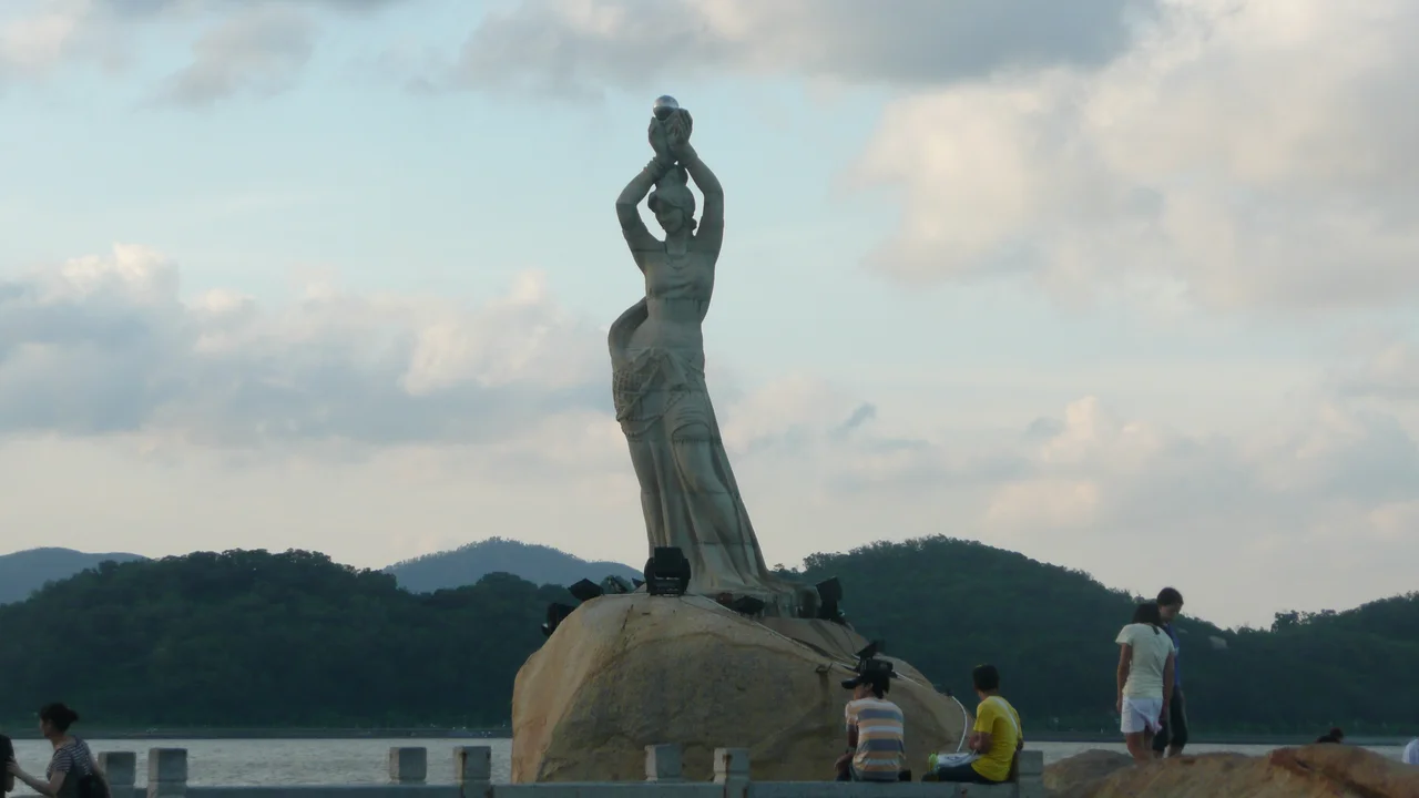 Long exposure of the Zhuhai Fisher Girl statue, a statue by Pan He erected in 1982. It is 8.7 meters tall and composed of 70 pieces of granite. The statue stands as a prominent landmark of the city of Zhuhai.