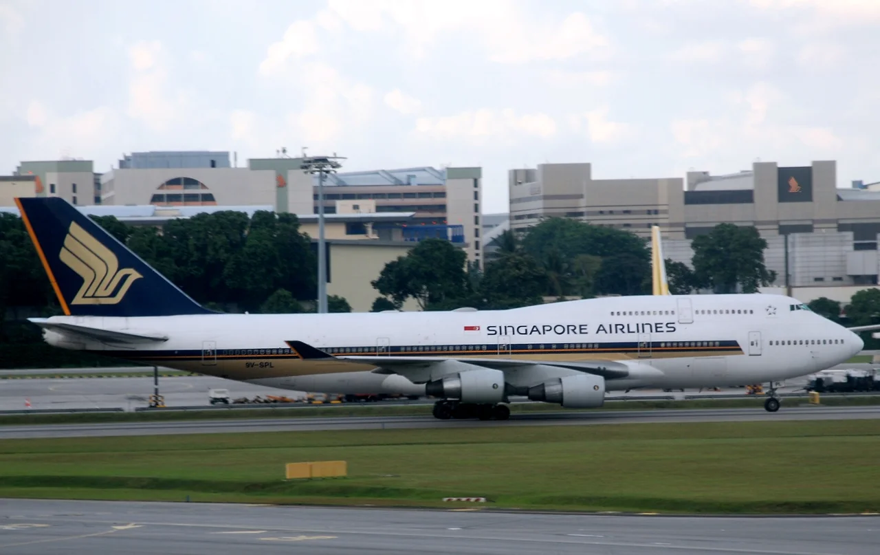 Singapore Airlines Boeing 747-400 (9V-SPL) at Singapore Changi Airport. (Other information: This plane was once painted in the "Tropical" livery which was used to promote the new cabin interiors in the late 1990s. However, after the Flight 6 crash, the plane was painted back in normal SIA colours.)