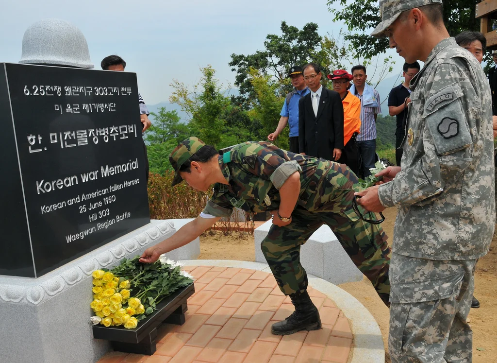 Victims of Hill 303 massacre showing bound hands in burial area near Waegwan, Korea.