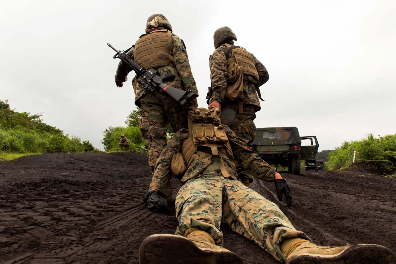 Marines with Combat Logistics Company 36 drag a casualty of an Improvised Explosive Device during Exercise Dragon Fire 2014 at Combined Arms Training Center Camp Fuji, Japan, July 19. While just a training event, Sgt. Paul Faucheux, an explosive ordnance disposal technician with Marine Corps Installations Pacific, said it provided junior Marines an introduction to IED strikes, allowed noncommissioned officers to teach, and challenged their combat leadership in countering IED strikes.

(U.S. Marine Corps photo by Cpl. Antonio Rubio/Released)
