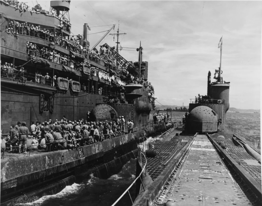 The United States Navy submarine tender USS Proteus (AS-19) (left) and Imperial Japanese Navy submarines Japanese submarine I-14 2 (center) and Japanese submarine I-400 2 (right) in port in Japan after the end of World War II.